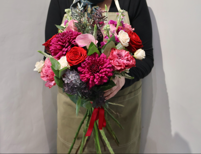 Peace and Joy by Octagon Flowers, Bolton - Vibrant hand-tied bouquet with red, pink and cream flowers, handcrafted by Octagon Flowers in Bolton. Perfect for birthdays, anniversaries & celebrations.