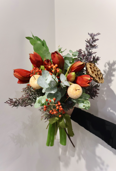 Amazing Grace - Bursting with rich seasonal colour, this stunning festive bouquet is hand-crafted by Fiona at Octagon Flowers in Bolton. Featuring elegant deep-red amaryllis, glossy eucalyptus, vibrant hypericum berries, and charming decorative Christmas apples, it’s a beautiful celebration of winter warmth.

Perfect as a luxurious gift or to add festive cheer to your home, this bouquet is lovingly made using fresh, premium stems sourced by your local independent florist.

Share the magic of Christmas with flowers that truly stand out.